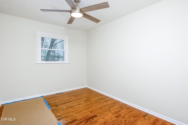 empty room featuring ceiling fan and hardwood / wood-style floors