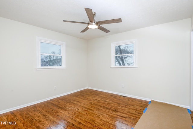 empty room with ceiling fan and wood-type flooring