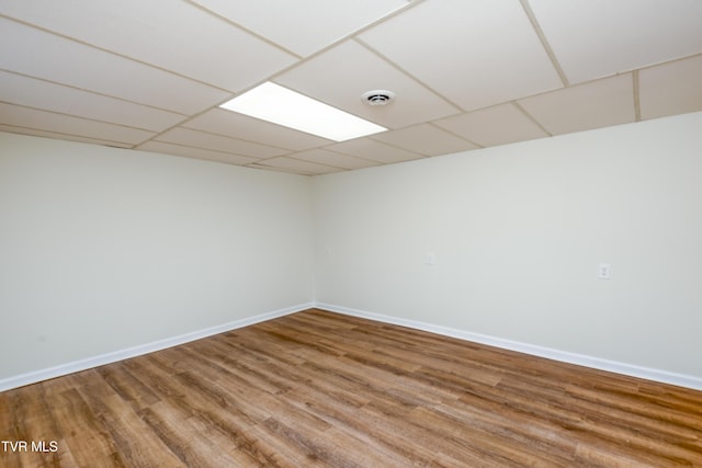 spare room with hardwood / wood-style flooring and a drop ceiling