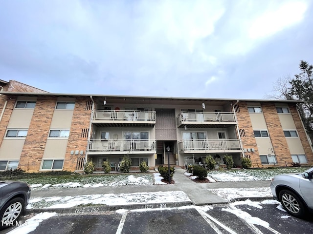 view of building exterior with uncovered parking