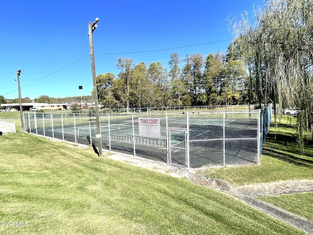 view of sport court with a yard