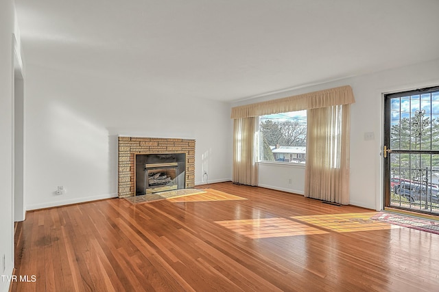 unfurnished living room with light wood-type flooring and a fireplace