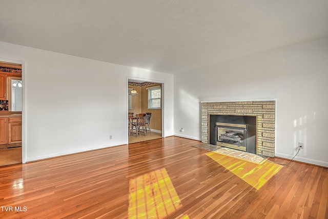 unfurnished living room featuring hardwood / wood-style floors and a fireplace