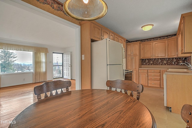 dining area with a textured ceiling and sink