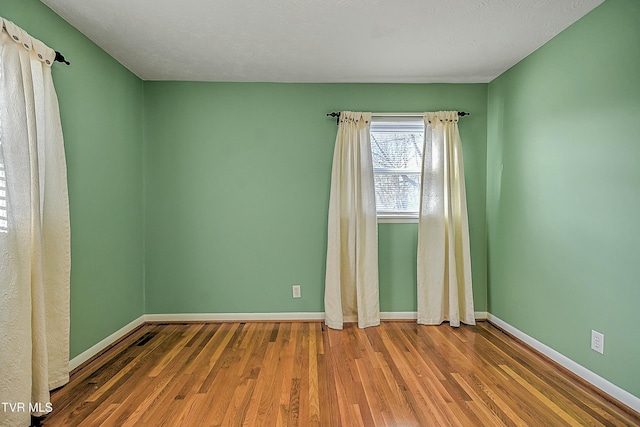 empty room featuring hardwood / wood-style floors and a textured ceiling