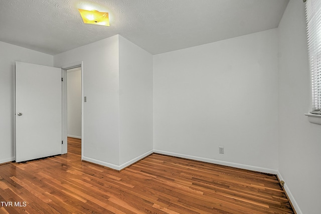 interior space featuring wood-type flooring and a textured ceiling