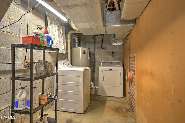 basement with electric water heater and independent washer and dryer