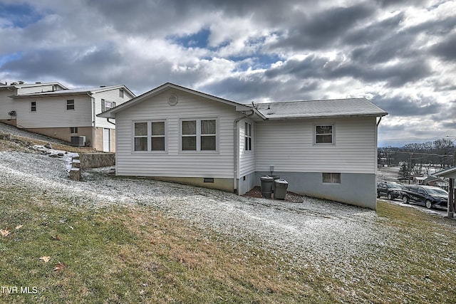 rear view of property with central AC unit