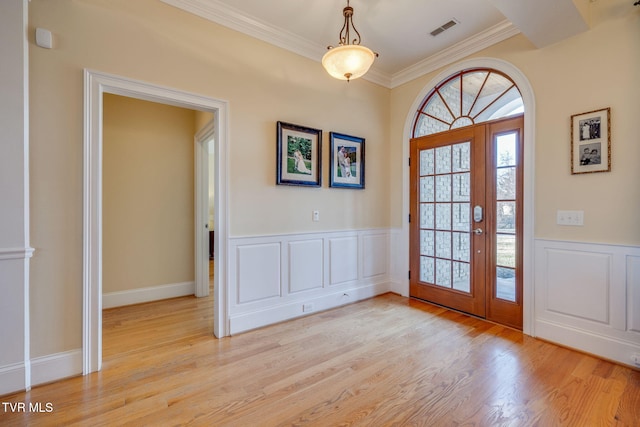 entrance foyer with light wood-type flooring and ornamental molding