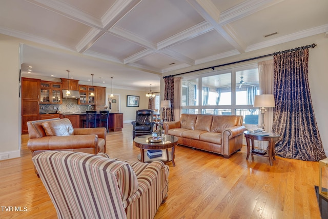 living room with beam ceiling, light hardwood / wood-style floors, crown molding, and coffered ceiling