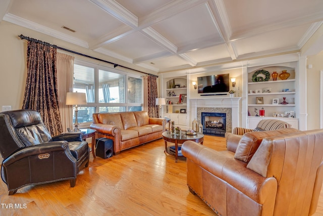 living room featuring beamed ceiling, built in features, ornamental molding, and coffered ceiling