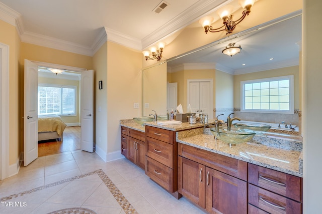 bathroom with crown molding, tile patterned flooring, vanity, and plenty of natural light