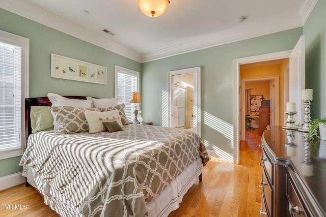 bedroom with multiple windows, light hardwood / wood-style floors, and ornamental molding