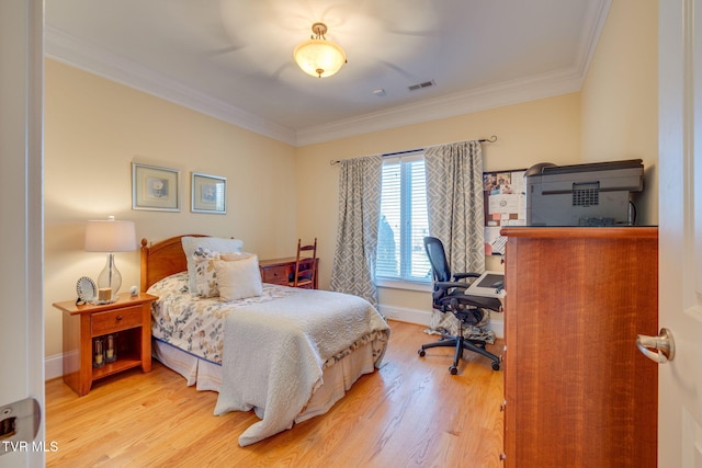 bedroom featuring light wood-type flooring and ornamental molding