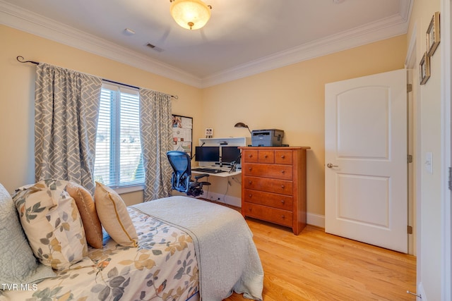 bedroom featuring crown molding and light wood-type flooring