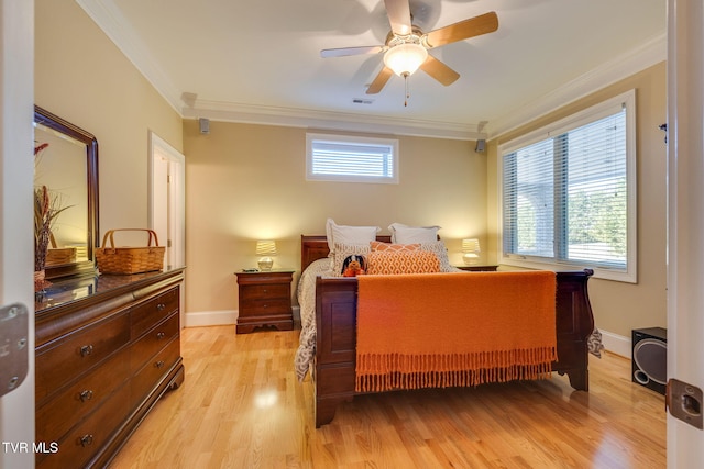 bedroom featuring multiple windows, light hardwood / wood-style flooring, ceiling fan, and crown molding