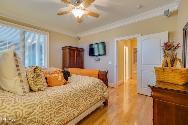 bedroom featuring ceiling fan, light hardwood / wood-style floors, and ornamental molding