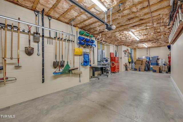 garage with electric panel and a garage door opener