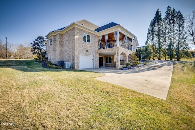 view of front of property with a balcony, a garage, a front lawn, and cooling unit