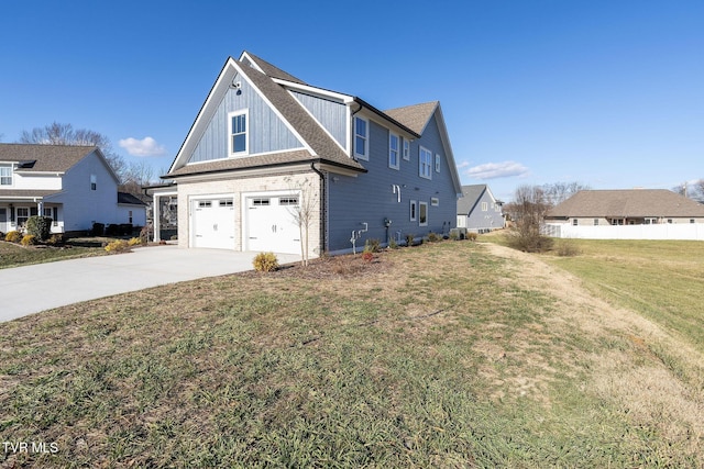 view of side of home featuring a garage and a lawn