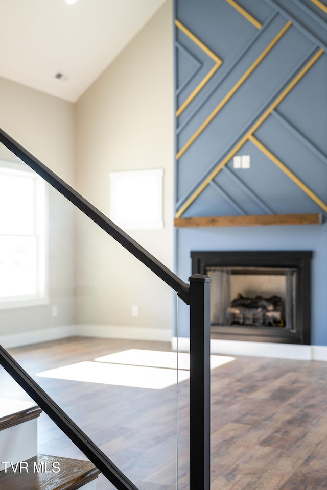 stairway featuring wood-type flooring and vaulted ceiling