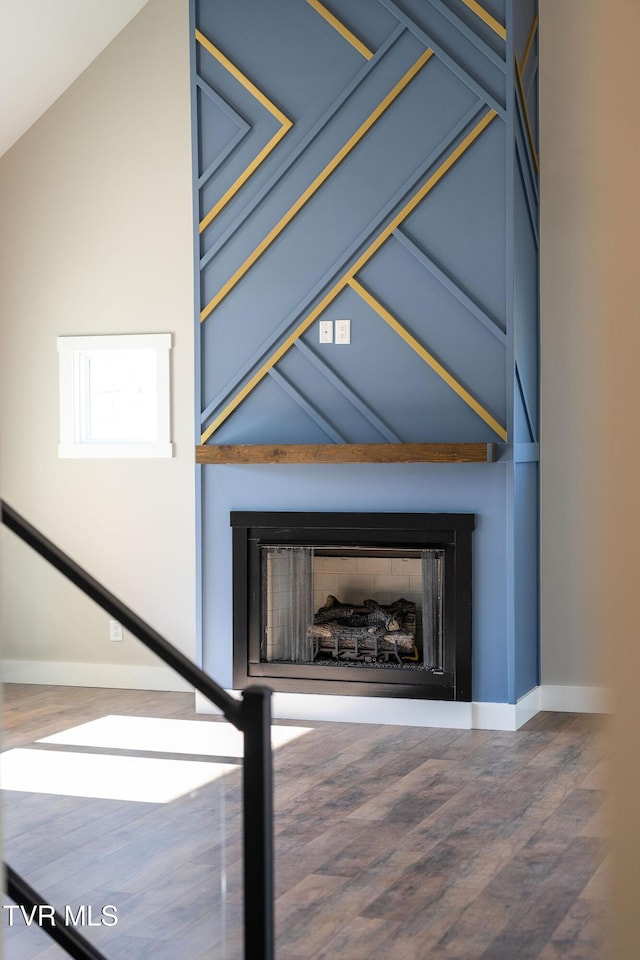 interior details featuring wood-type flooring and a fireplace