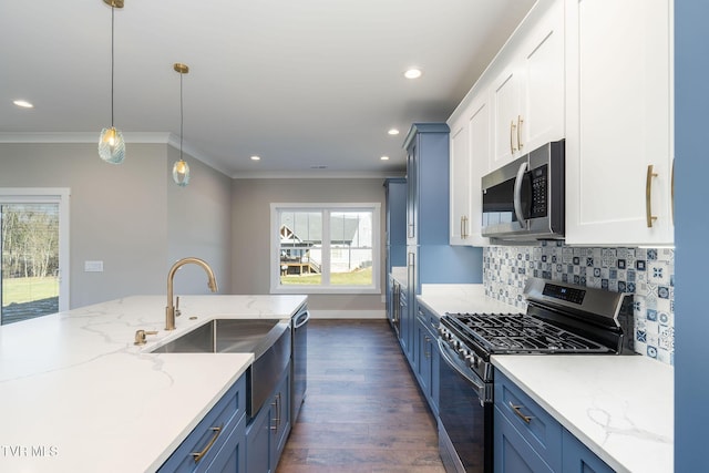 kitchen with appliances with stainless steel finishes, blue cabinetry, tasteful backsplash, pendant lighting, and light stone counters