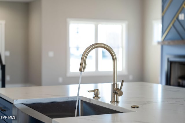 interior details featuring blue cabinetry and sink