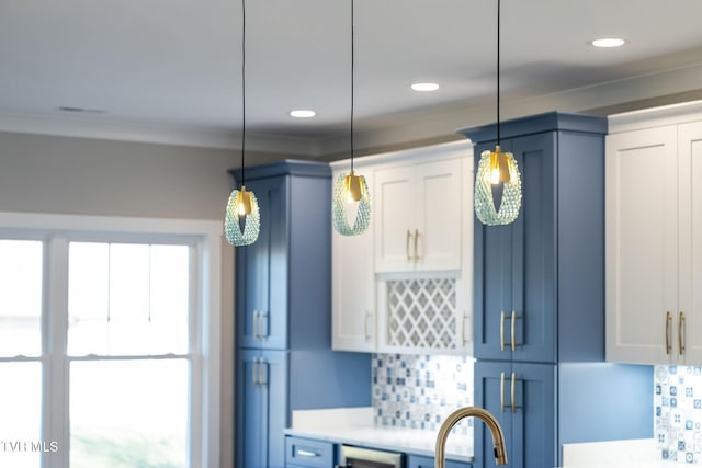 kitchen featuring blue cabinetry, white cabinets, tasteful backsplash, and decorative light fixtures