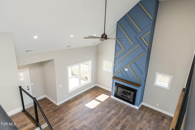 unfurnished living room featuring dark wood-type flooring and lofted ceiling