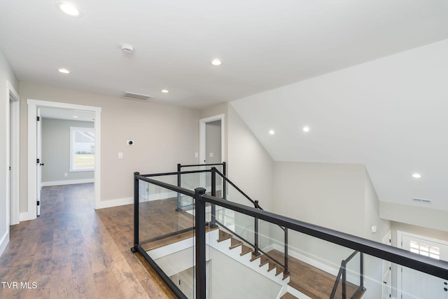 corridor featuring lofted ceiling and wood-type flooring