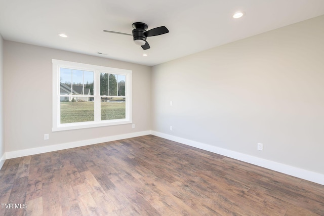 spare room with ceiling fan and wood-type flooring