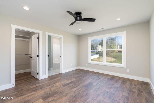 unfurnished bedroom featuring ceiling fan, dark hardwood / wood-style floors, a closet, and ensuite bathroom