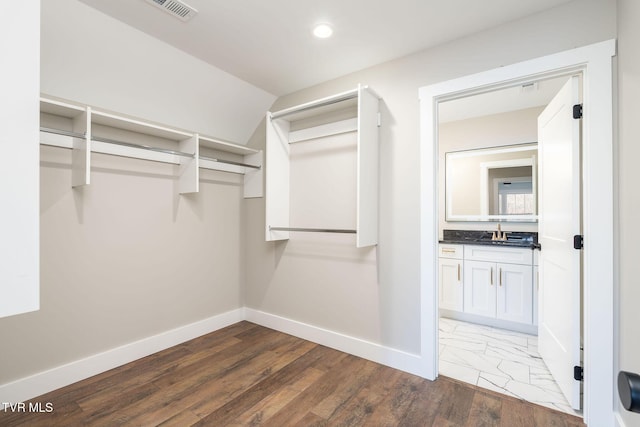 walk in closet featuring dark hardwood / wood-style floors and sink