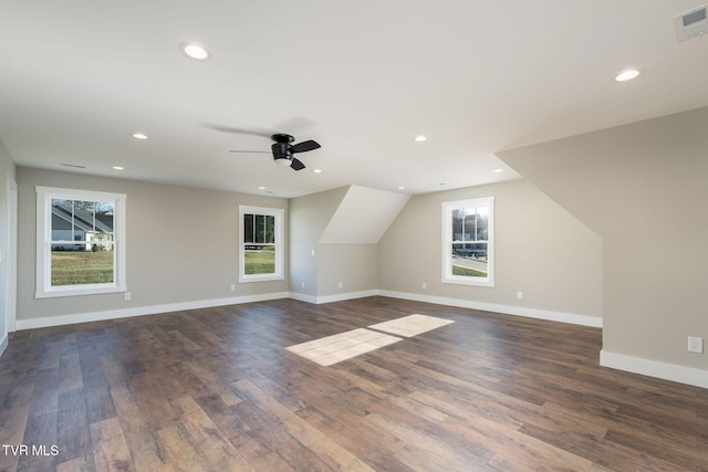 bonus room with vaulted ceiling, a healthy amount of sunlight, and dark hardwood / wood-style floors