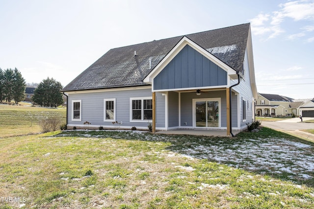 rear view of house with ceiling fan, a lawn, and a patio