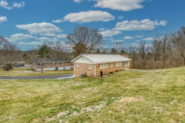 single story home with a front yard and central AC