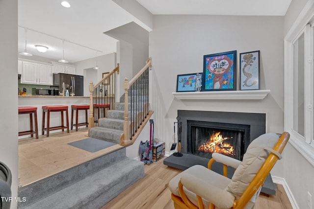 interior space featuring hardwood / wood-style flooring and vaulted ceiling