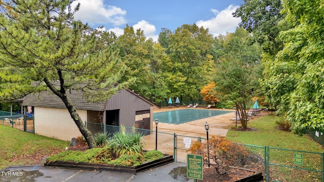 view of pool with an outdoor structure