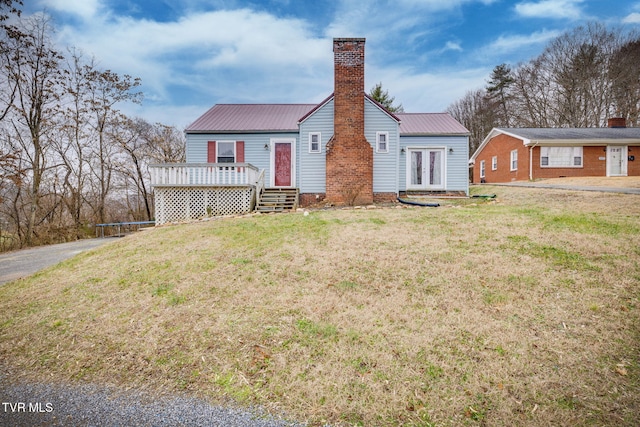 rear view of house featuring french doors, a yard, a trampoline, and a wooden deck