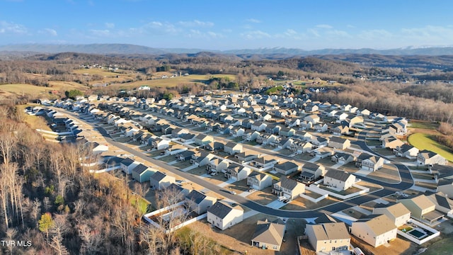 birds eye view of property with a mountain view