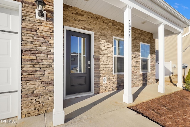 view of exterior entry featuring a porch