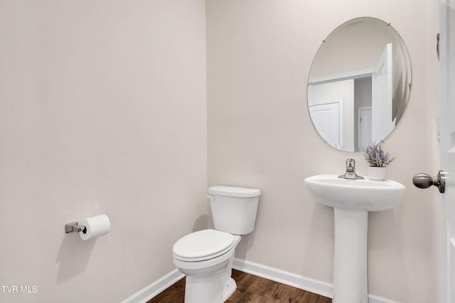 bathroom featuring hardwood / wood-style floors, toilet, and sink