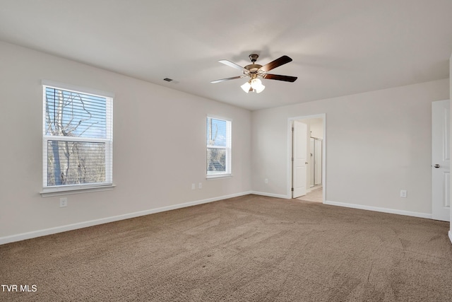 carpeted empty room featuring ceiling fan and a healthy amount of sunlight