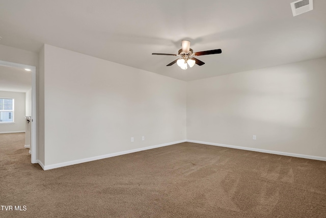 carpeted empty room featuring ceiling fan