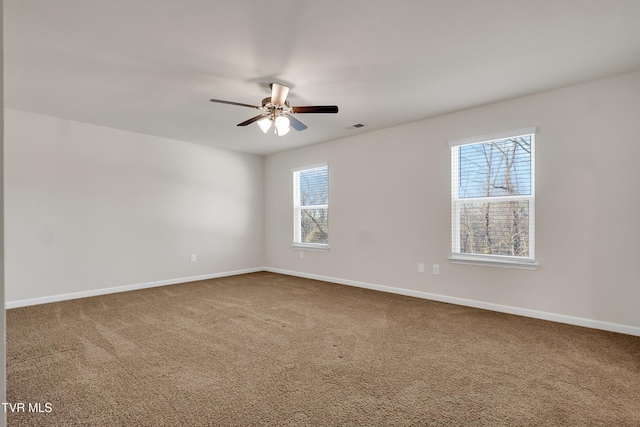 empty room featuring carpet floors and ceiling fan