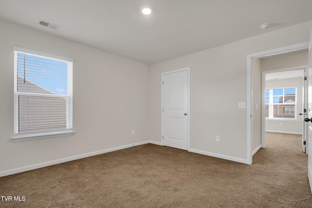 unfurnished room featuring carpet flooring