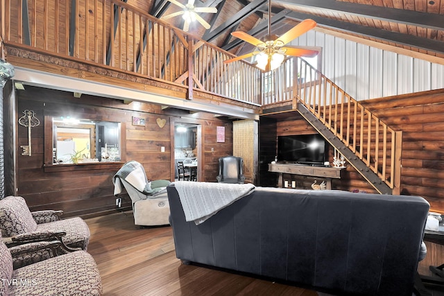 living room featuring wood ceiling, ceiling fan, hardwood / wood-style flooring, high vaulted ceiling, and beamed ceiling