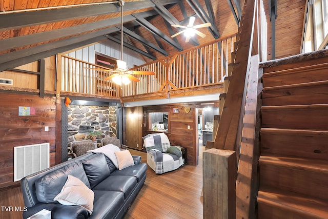 living room with wood ceiling, ceiling fan, wood-type flooring, beam ceiling, and high vaulted ceiling