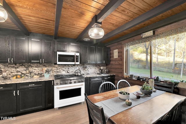 kitchen featuring beamed ceiling, light stone counters, high end stainless steel range oven, and light hardwood / wood-style flooring